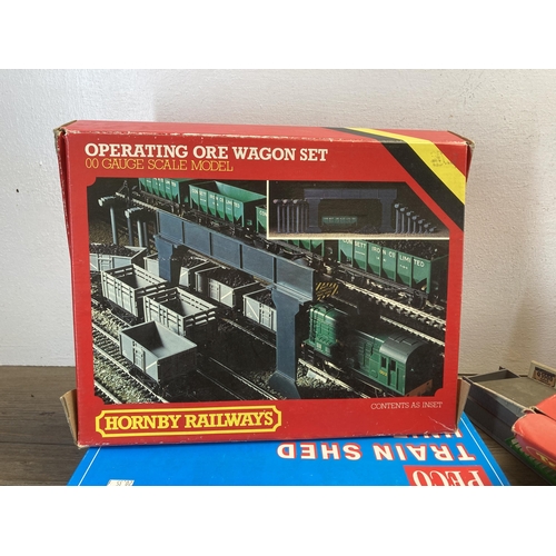 343 - A large collection of Hornby and Peco model railway buildings and accessories