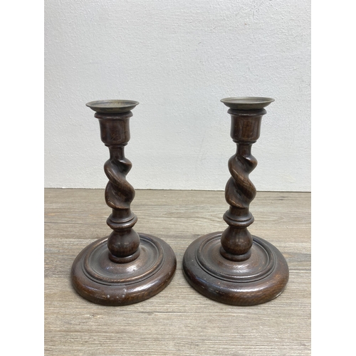 537 - Three vintage oak items, two barley twist candlesticks and one ships wheel ashtray