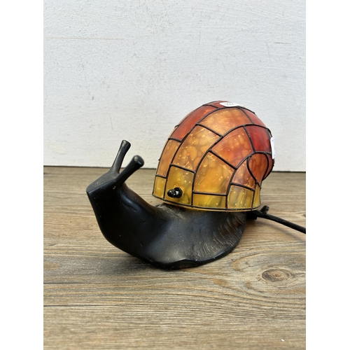 496 - A Tiffany style snail table lamp - approx. 13cm high x 25cm long