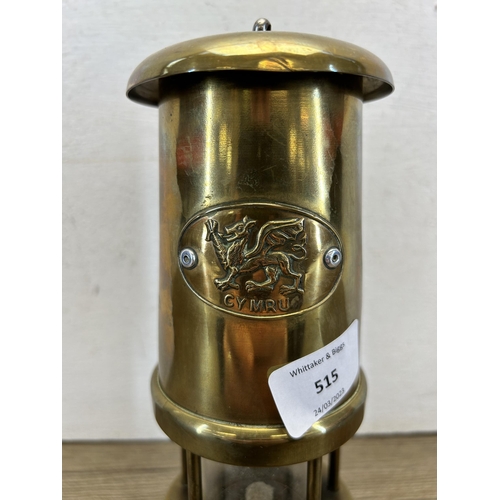 515 - A Welsh brass miner's lamp - approx. 23cm high