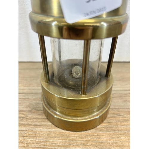 515 - A Welsh brass miner's lamp - approx. 23cm high