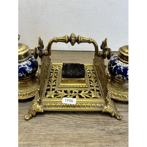 523 - A mid 20th century brass and ceramic inkwell - approx. 13cm high x 33cm wide x 15cm deep