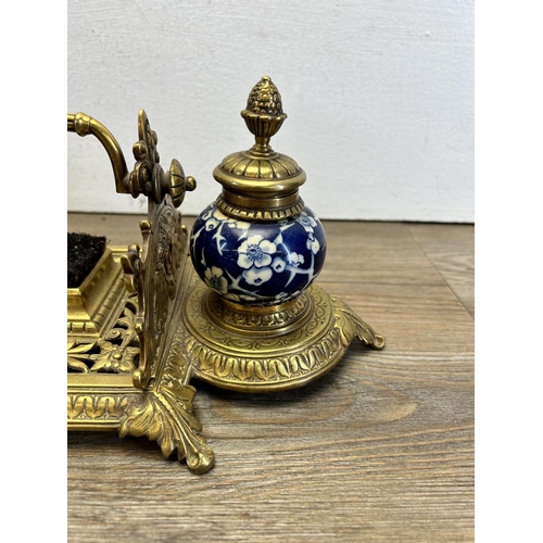 523 - A mid 20th century brass and ceramic inkwell - approx. 13cm high x 33cm wide x 15cm deep