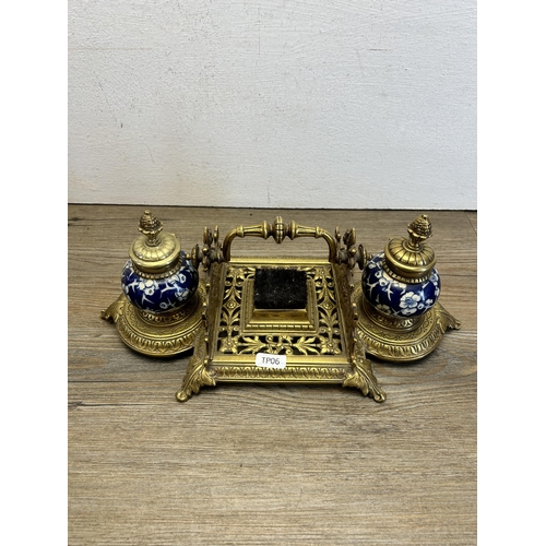 523 - A mid 20th century brass and ceramic inkwell - approx. 13cm high x 33cm wide x 15cm deep