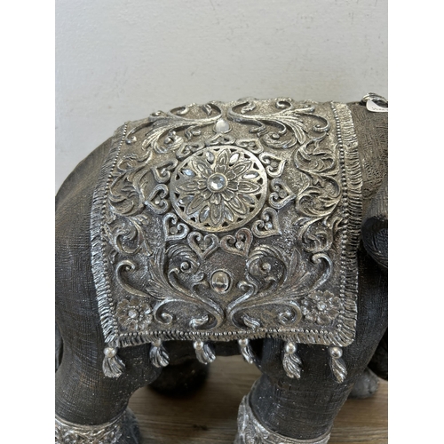 525 - A modern resin model of an elephant - approx. 34cm high x 47cm long