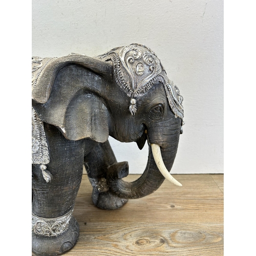 525 - A modern resin model of an elephant - approx. 34cm high x 47cm long