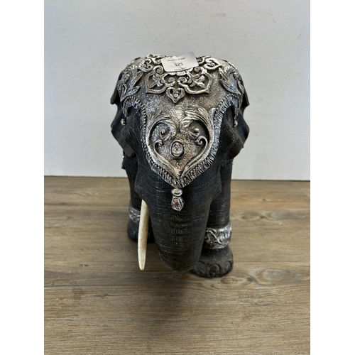 525 - A modern resin model of an elephant - approx. 34cm high x 47cm long