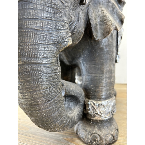 525 - A modern resin model of an elephant - approx. 34cm high x 47cm long