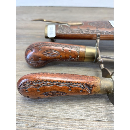 529 - An Indian hardwood and brass two piece carving set