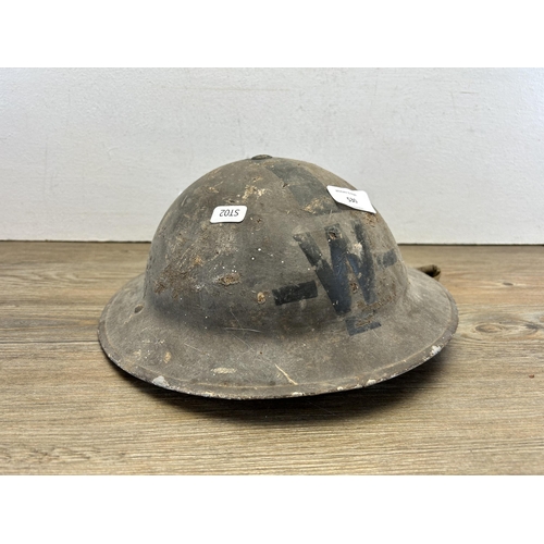 530 - Two items, one WWII wardens helmet and one pair of Eastern European trousers