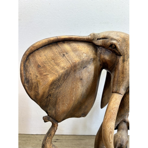 532 - An African carved teak elephant sculpture - approx. 42cm high x 32cm wide