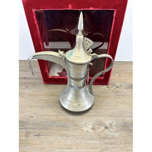 533 - A red velvet cased Middle Eastern metal coffee pot