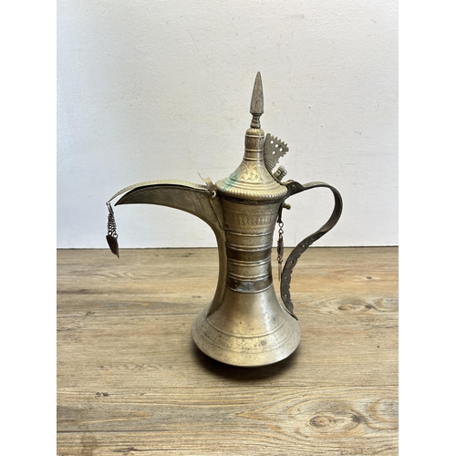 533 - A red velvet cased Middle Eastern metal coffee pot