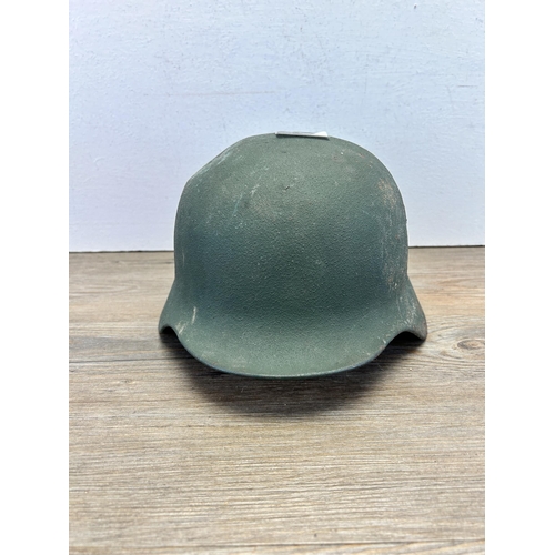 559 - A post WWII German helmet stamped LS 64