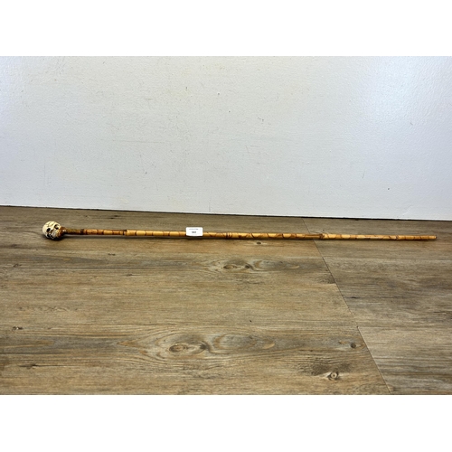 562 - A 19th century style memento mori walking cane - approx. 92cm long