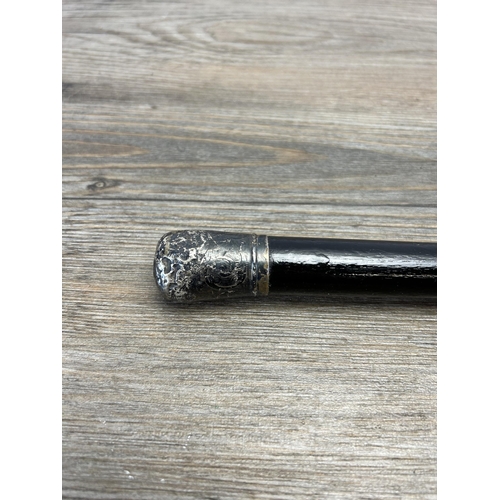 563 - An early 20th century ebonised walking cane with hallmarked Chester silver top, dated 1912 - approx.... 