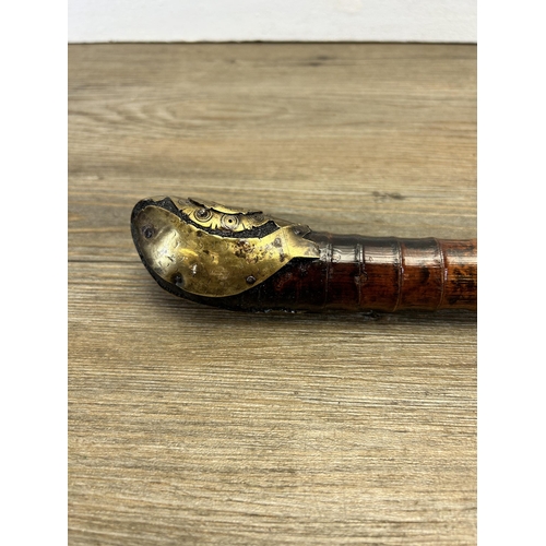 564 - A 19th century Oriental bamboo opium pipe with brass fish design - approx. 53cm long