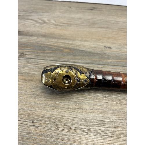 564 - A 19th century Oriental bamboo opium pipe with brass fish design - approx. 53cm long