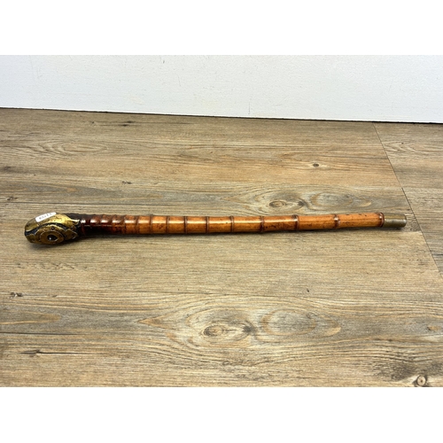 564 - A 19th century Oriental bamboo opium pipe with brass fish design - approx. 53cm long