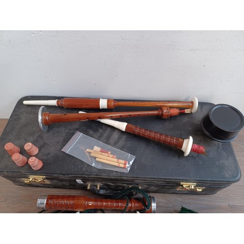 733 - A cased set of bagpipes with practice chanter