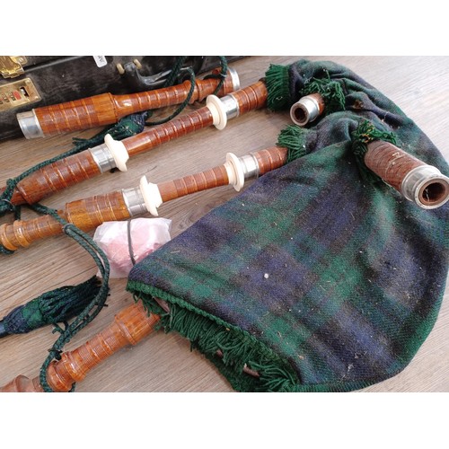 733 - A cased set of bagpipes with practice chanter