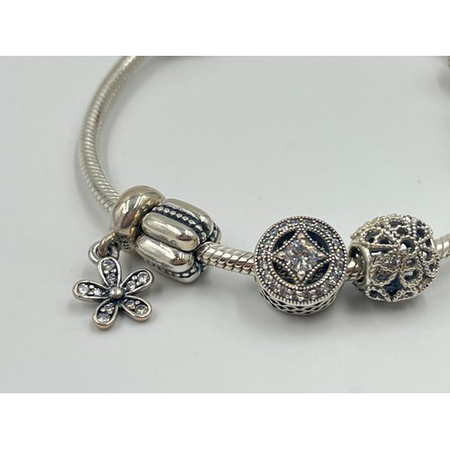 1176 - A boxed Pandora .925 silver charm bracelet with charms - approx. gross weight 34 grams