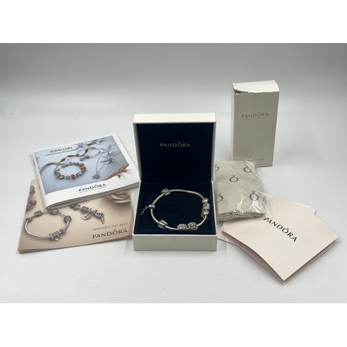 1176 - A boxed Pandora .925 silver charm bracelet with charms - approx. gross weight 34 grams