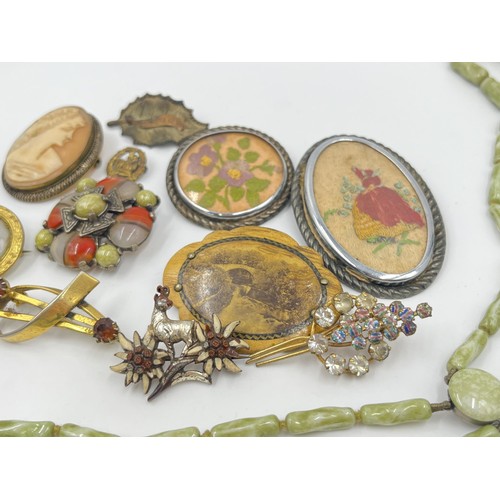 1201 - A collection of vintage costume jewellery to include Miracle brooch, cameo brooch etc.