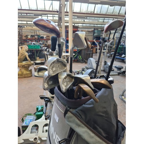 812A - A Ping golf bag containing thirteen golf clubs to include Tailormade S-90+, Ping ST Titanium etc.