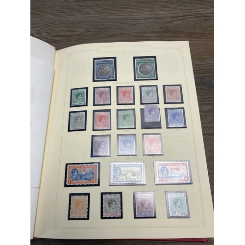 476 - Two Stanley Gibbons stamp albums containing worldwide stamps to include Fiji, Bahamas, Cook Islands,... 