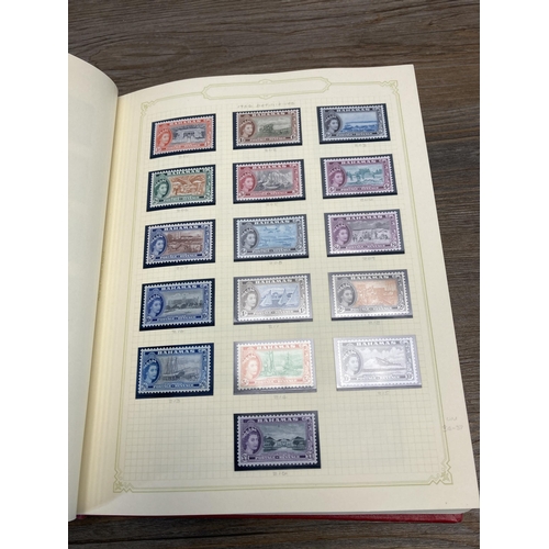 476 - Two Stanley Gibbons stamp albums containing worldwide stamps to include Fiji, Bahamas, Cook Islands,... 