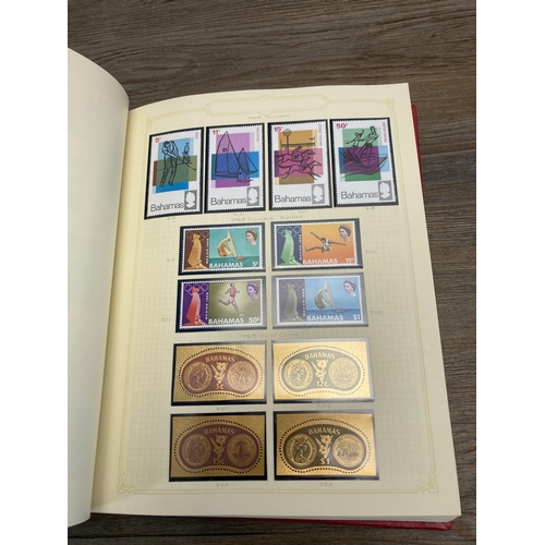 476 - Two Stanley Gibbons stamp albums containing worldwide stamps to include Fiji, Bahamas, Cook Islands,... 