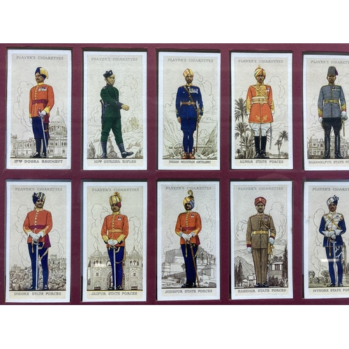 491 - A framed collection of 1930s John Player & Sons Military Uniforms of the British Empire Overseas cig... 