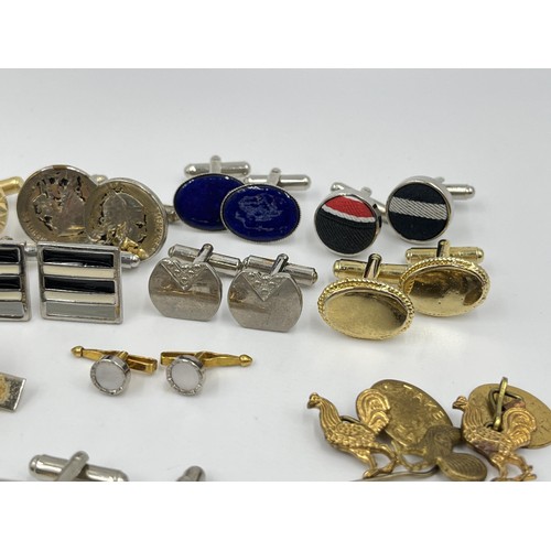 1211 - A collection of cufflinks and tie pins to include Stratton, Rolls Royce etc.