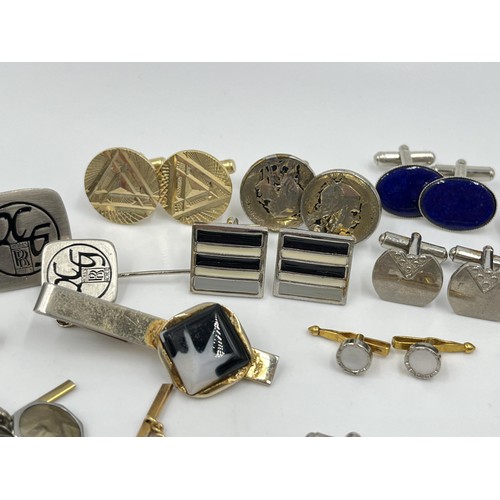 1211 - A collection of cufflinks and tie pins to include Stratton, Rolls Royce etc.