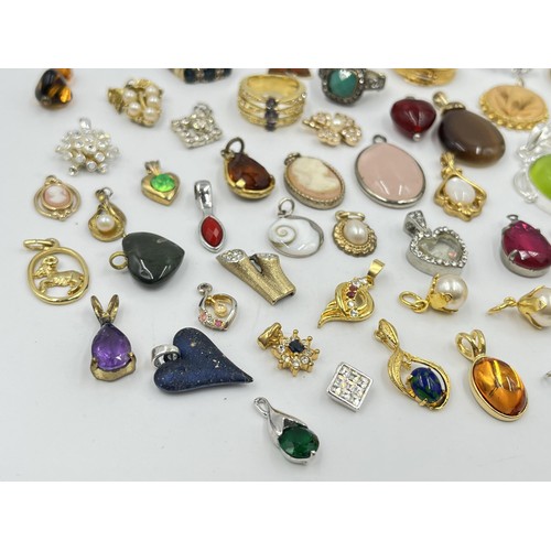 1215 - A collection of pendants and dress rings