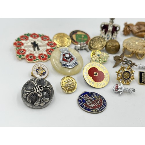 1216 - A collection of badges and buttons to include military etc.