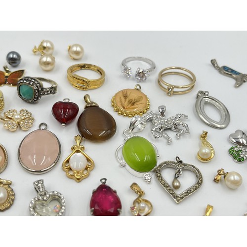 1215 - A collection of pendants and dress rings