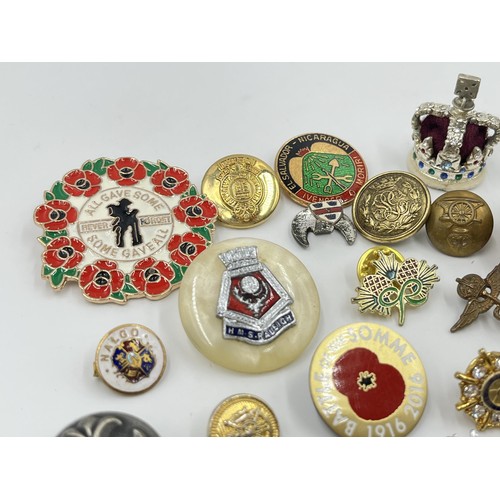 1216 - A collection of badges and buttons to include military etc.