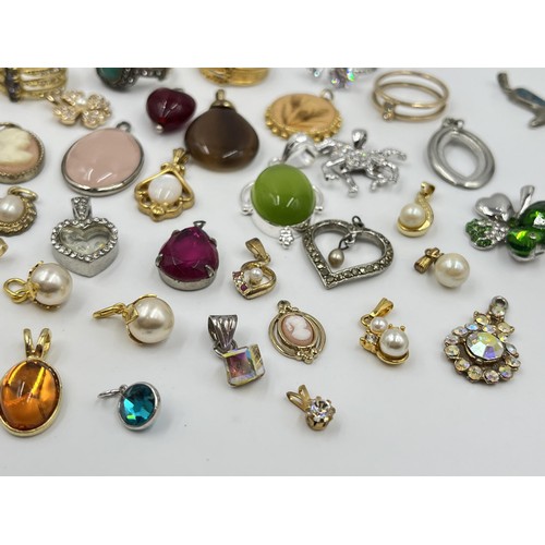 1215 - A collection of pendants and dress rings