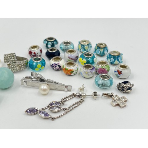 1221 - A collection of .925 silver charms, earrings and rings