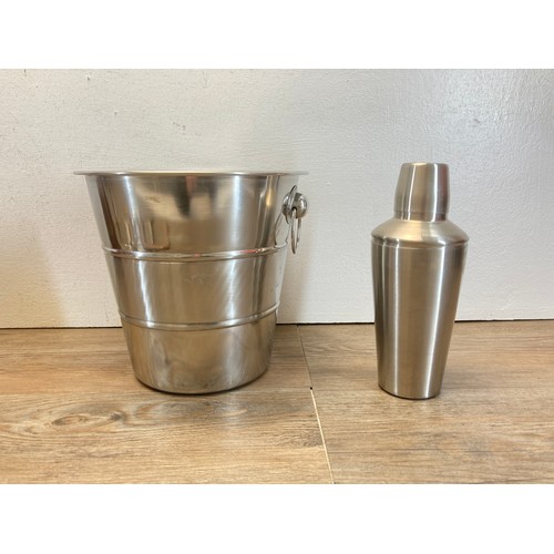 265 - A collection of breweriana to include bottle openers, stainless steel champagne bucket etc.