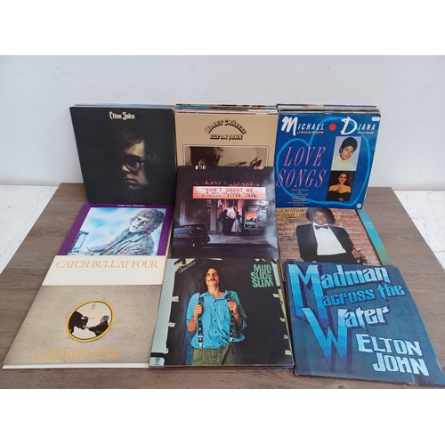 718 - A collection of LP vinyl records to include Cat Stevens, Elton John, Eurythmics, Peter Gabriel, Simp... 