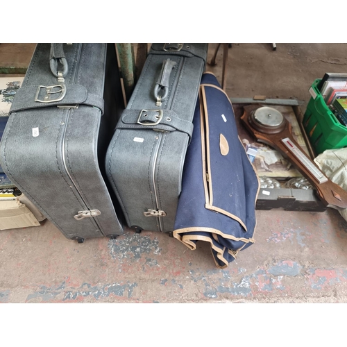 902 - Four boxes containing household items to include two Constellation suitcases, Benn Franks Ltd oak ba... 