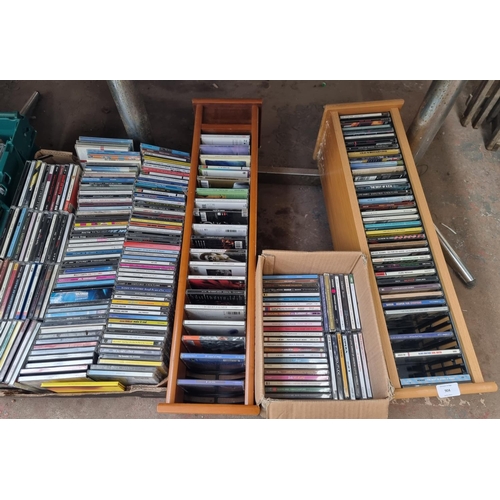 904 - Five boxes and two CD racks containing a large quantity of CDs