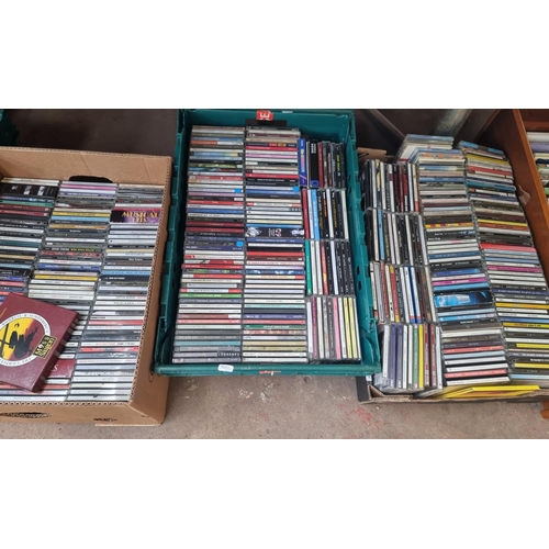 904 - Five boxes and two CD racks containing a large quantity of CDs