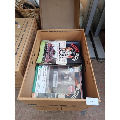 936 - A box containing a large quantity of United Review football programs