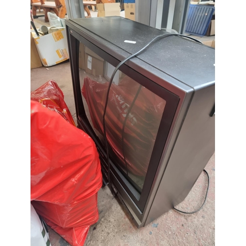 971 - A large collection of house clearance items to include Hitachi transistor colour TV, DVDs, cushions ... 