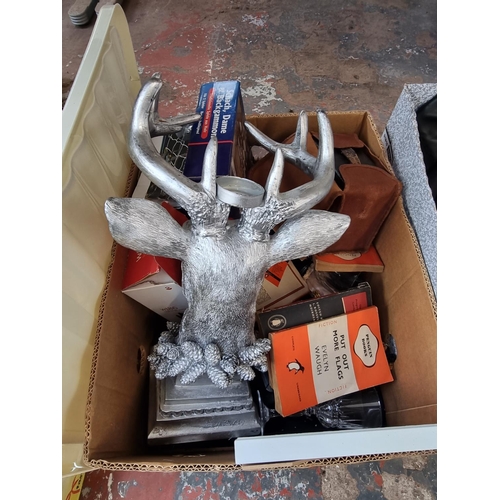 975 - Two boxes containing house clearance items to include contemporary stag candle holder, vintage pengu... 