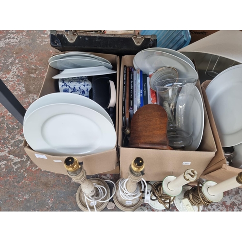 986 - Four boxes containing house clearance items to include table lamps, silver plated cutlery, ceramics,... 